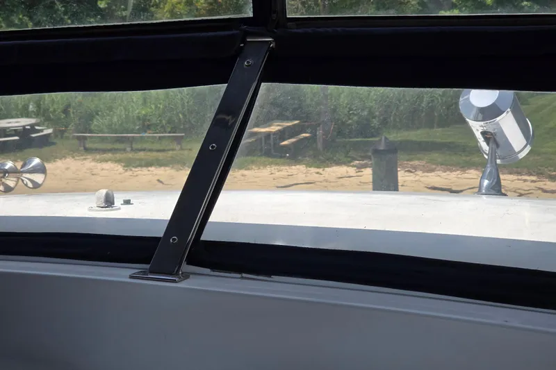 Slide: The Image of View from Grand Harbour 58 yacht, 2004, showing beach and greenery through window. - 99