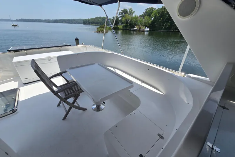 Slide: The Image of Outdoor seating area on a 2004 Grand Harbour 58 yacht overlooking serene waters. - 81
