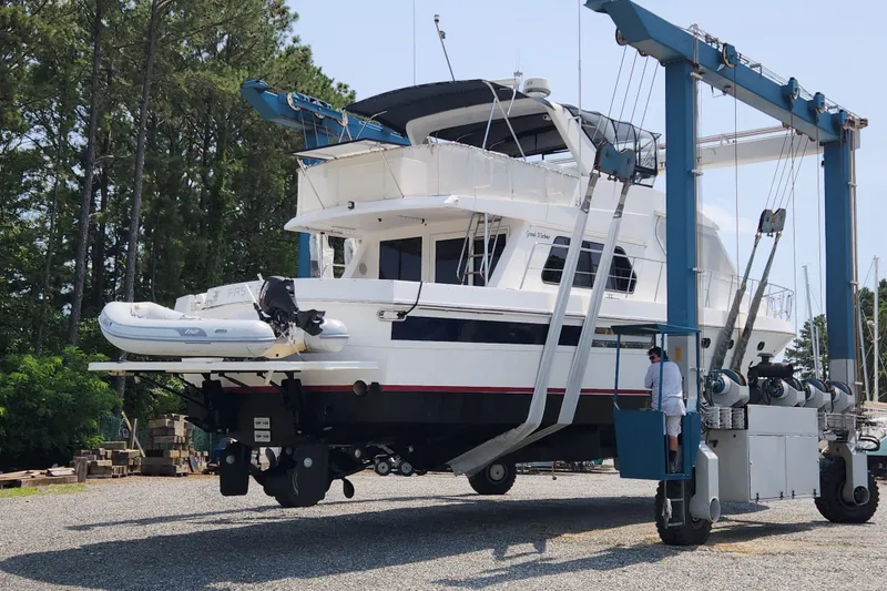 Slide: The Image of Grand Harbour 58 yacht from 2004 being lifted by a boat hoist in a marina. - 138