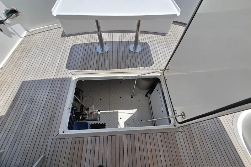Slide: The Image of Open hatch on 2004 Grand Harbour 58 yacht deck, revealing storage compartment. - 100
