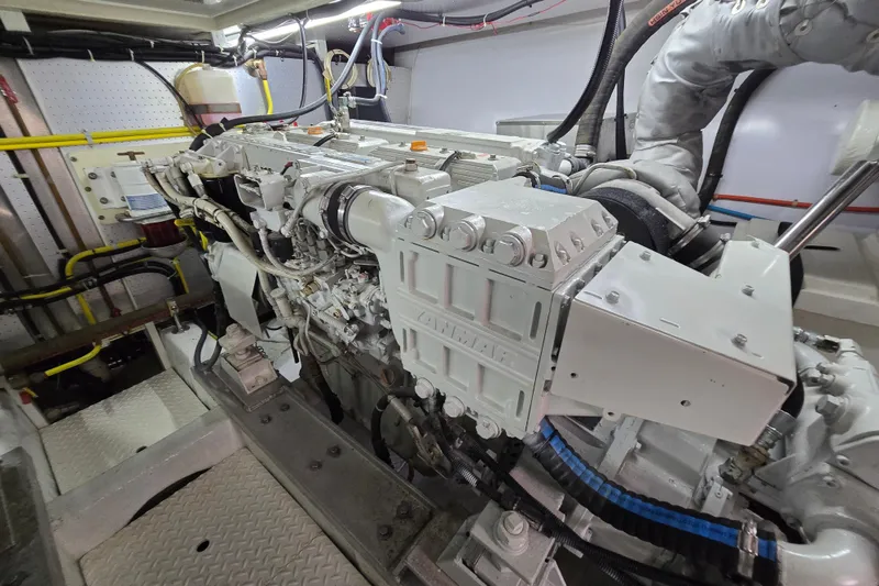 Slide: The Image of Engine room of a 2004 Grand Harbour 58 yacht, showcasing detailed machinery and components. - 121