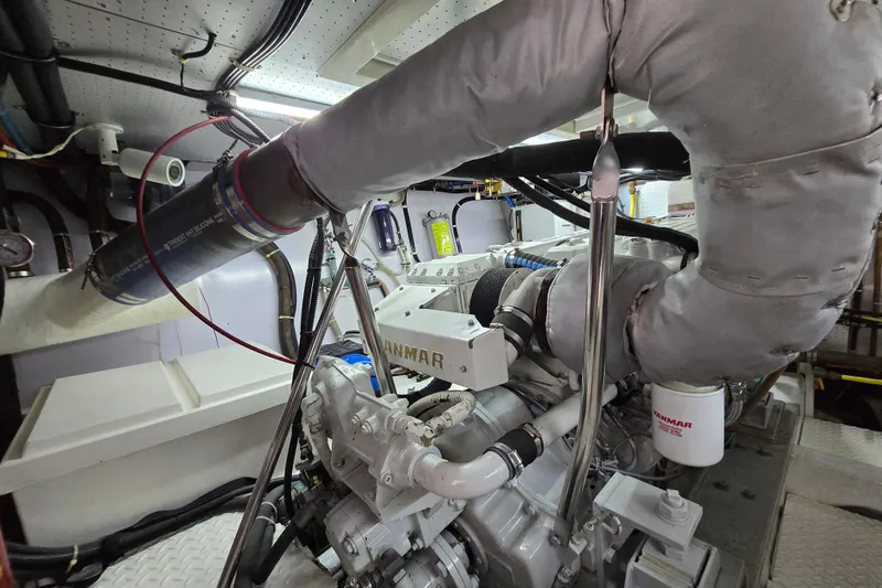 Slide: The Image of Engine room of a 2004 Grand Harbour 58 yacht, featuring a Yanmar engine. - 117