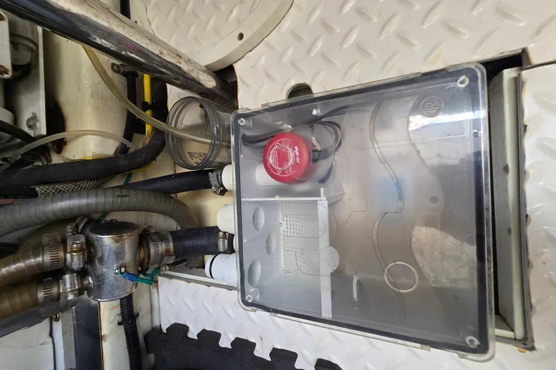 Slide: The Image of Engine room of 2004 Grand Harbour 58 yacht, featuring mechanical components and wiring. - 132