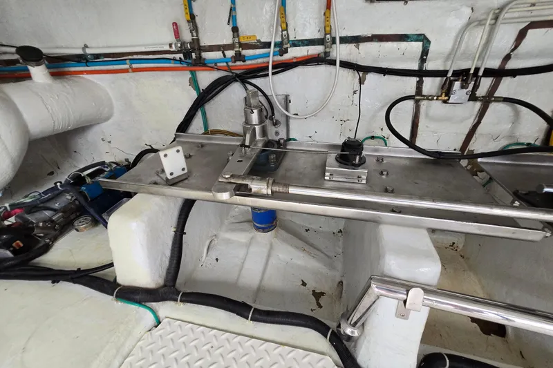 Slide: The Image of Engine room of a 2004 Grand Harbour 58 yacht, showcasing mechanical components and wiring. - 115