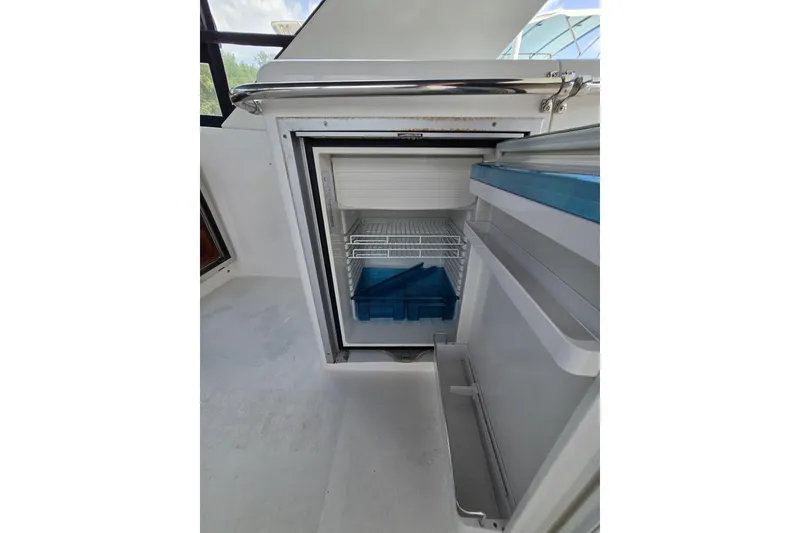 Slide: The Image of Open refrigerator on 2004 Grand Harbour 58 yacht, showcasing interior shelves and storage. - 83
