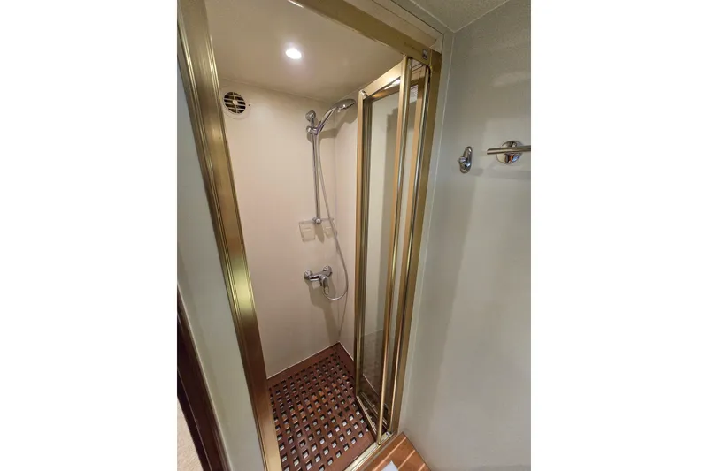 Slide: The Image of Shower area in 2004 Grand Harbour 58 yacht with glass door and wooden floor. - 52