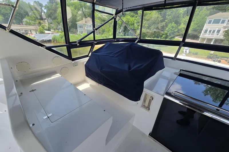 Slide: The Image of Interior view of 2004 Grand Harbour 58 yacht with covered seating and large windows. - 80