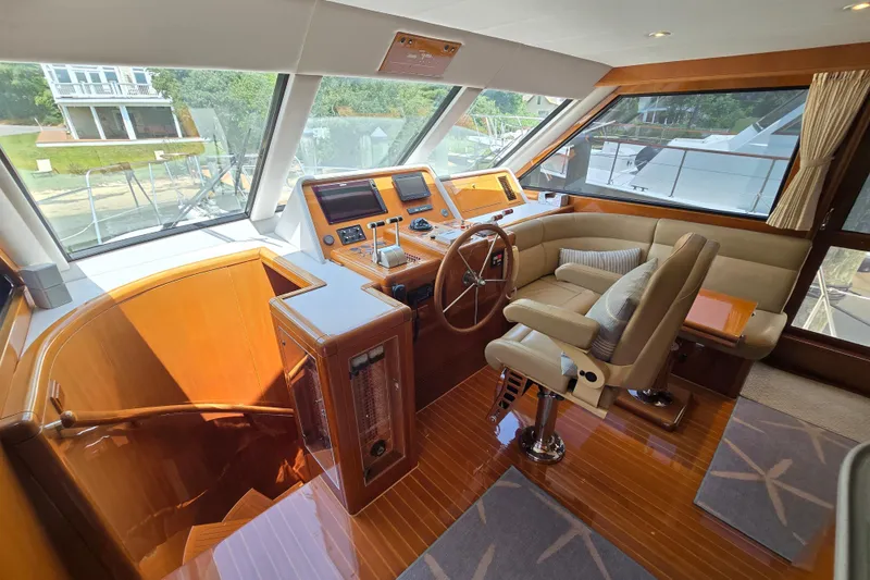 Slide: The Image of Luxurious 2004 Grand Harbour 58 yacht interior with helm, plush seating, and polished wood finishes. - 21