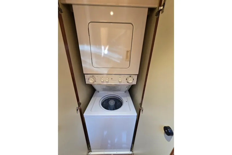 Slide: The Image of Stacked washer and dryer unit inside a 2004 Grand Harbour 58 yacht. - 62