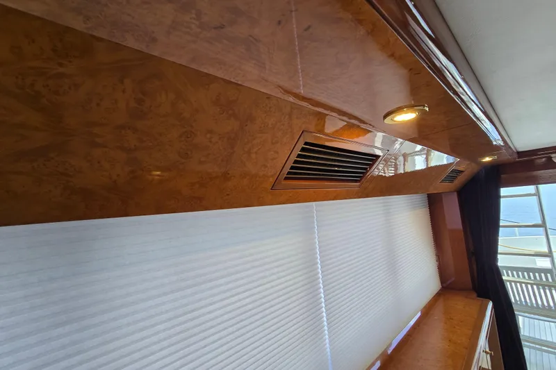Slide: The Image of Luxurious wooden interior of 2004 Grand Harbour 58 yacht with elegant lighting and window blinds. - 16