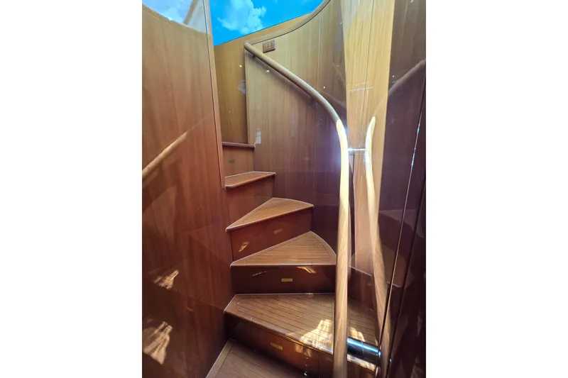 Slide: The Image of Wooden spiral staircase inside 2004 Grand Harbour 58 yacht, showcasing elegant craftsmanship. - 75