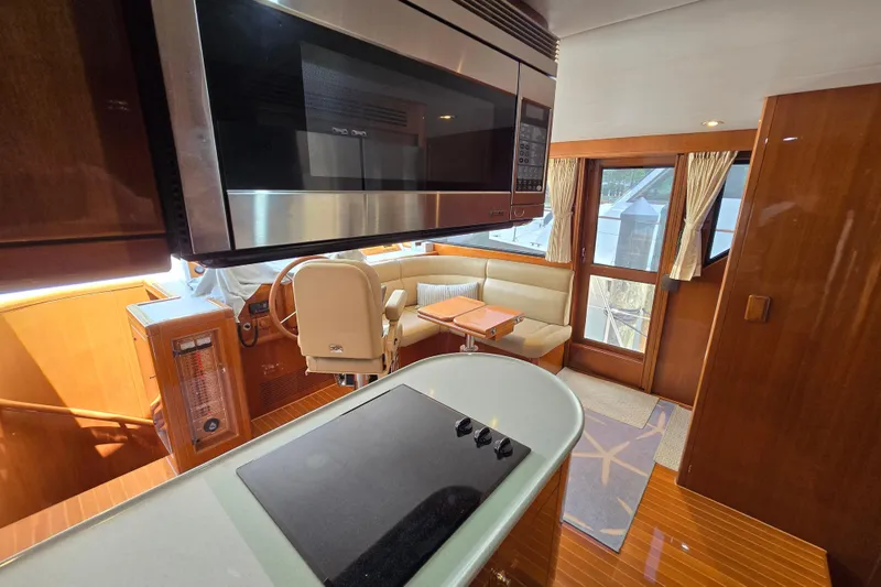 Slide: The Image of Luxurious interior of 2004 Grand Harbour 58 yacht with modern kitchen and seating area. - 39