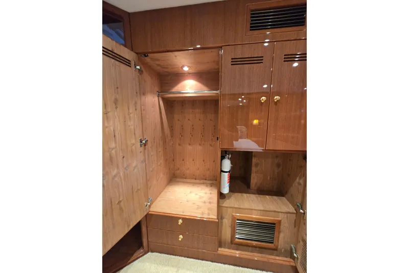 Slide: The Image of Luxurious wooden interior of 2004 Grand Harbour 58 yacht with storage and fire extinguisher. - 49