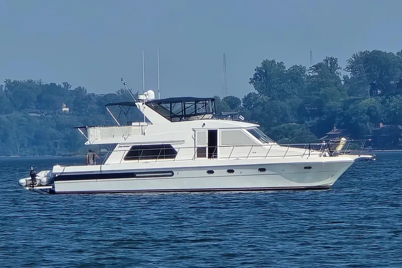 Slide: The Image of Luxury Grand Harbour 58 yacht from 2004 cruising on a serene lake. - 2