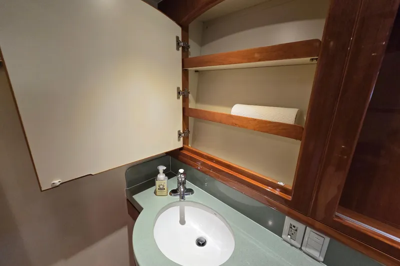 Slide: The Image of Luxury yacht bathroom with open cabinet, sink, and soap dispenser, Grand Harbour 58, 2004 model. - 53