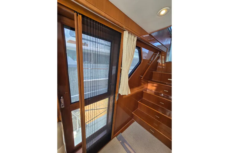 Slide: The Image of Interior of 2004 Grand Harbour 58 yacht with wooden stairs and sliding door. - 78