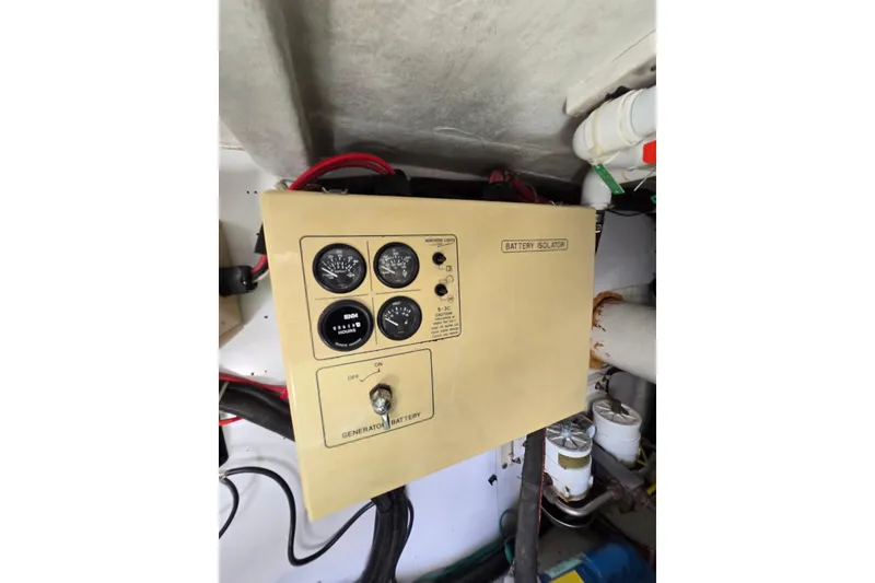 Slide: The Image of Control panel of a 2004 Grand Harbour 58 yacht, featuring battery isolator and gauges. - 128