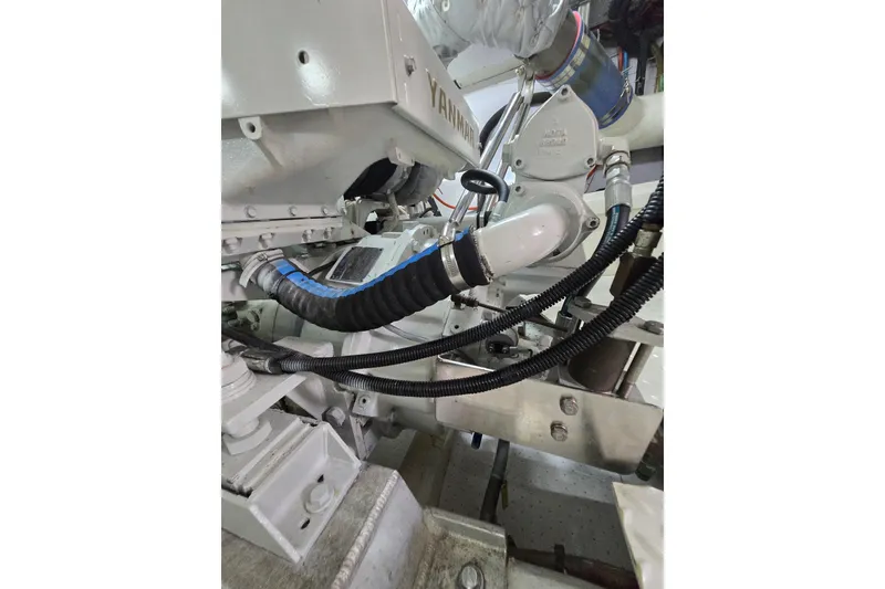 Slide: The Image of Engine components of a 2004 Grand Harbour 58 yacht, featuring Yanmar parts and hoses. - 119