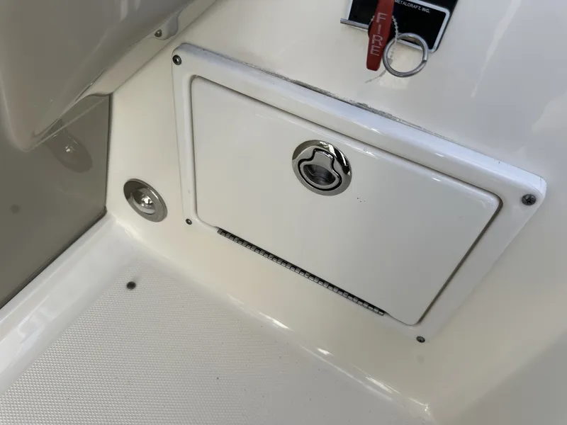 Slide: The Image of A white boat with a small storage compartment and a fire extinguisher. - 46