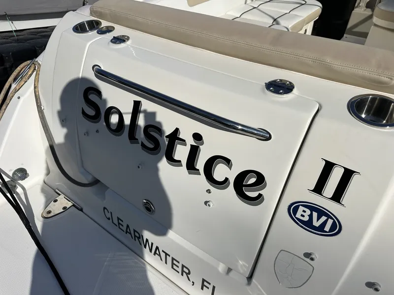 Slide: The Image of The stern of a Sea Ray Sundancer 260 named "Solstice II" with a BVI logo. - 20