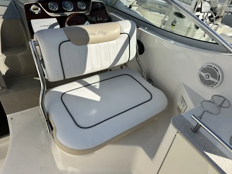 Slide: The Image of The image shows the helm of a 2010 Sea Ray Sundancer 260 with a cushioned seat. - 39
