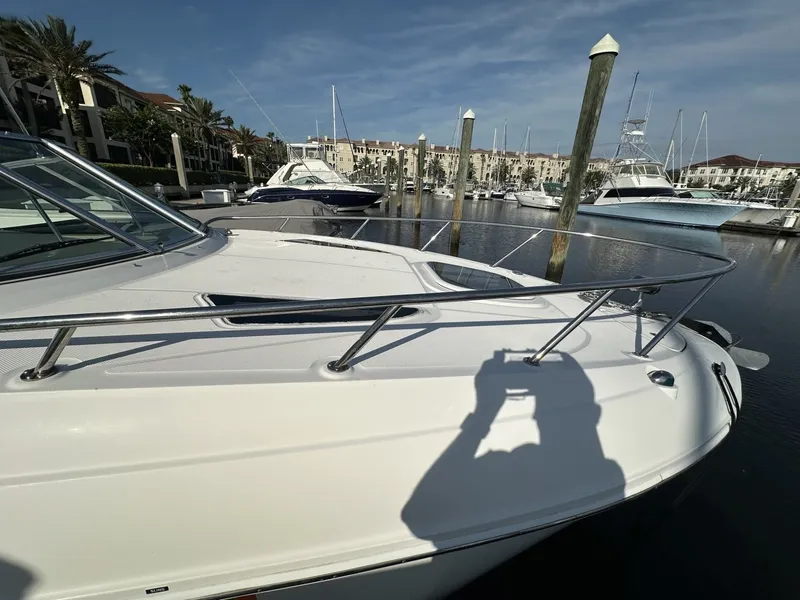 Slide: The Image of A 2010 Sea Ray Sundancer 260 docked in a marina. Several boats are visible in the background. - 15
