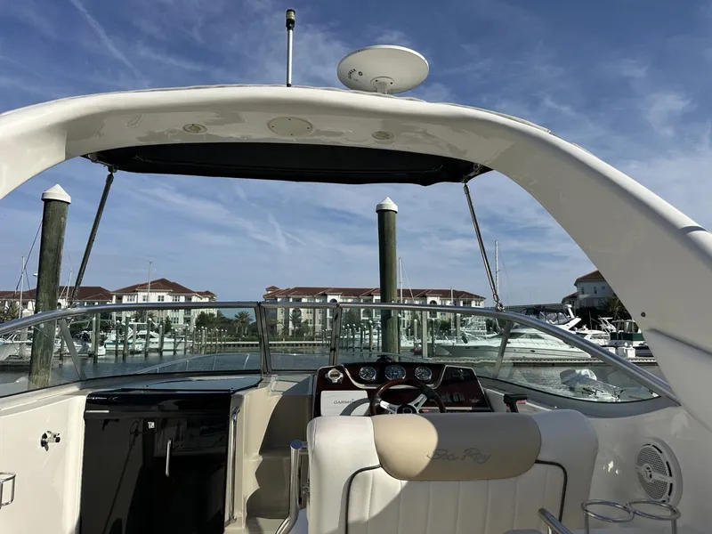 Slide: The Image of The image shows the cockpit of a 2010 Sea Ray Sundancer 260 in a marina. - 31