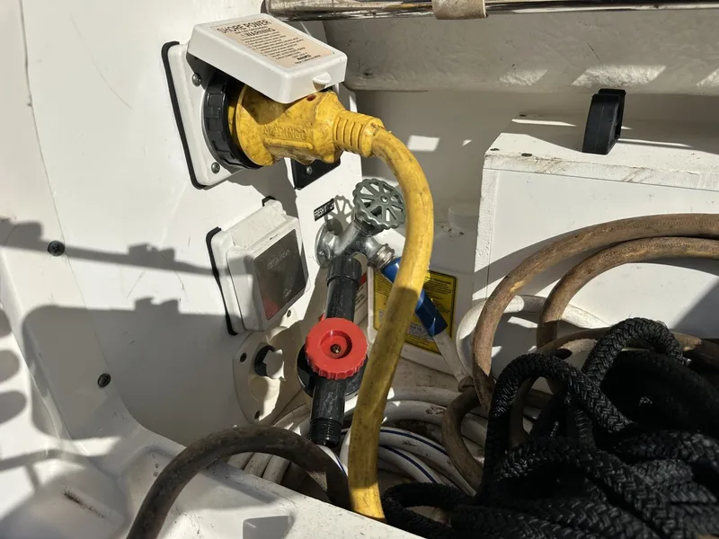 Slide: The Image of A boat with a yellow power cable and black ropes in the cockpit area. - 22