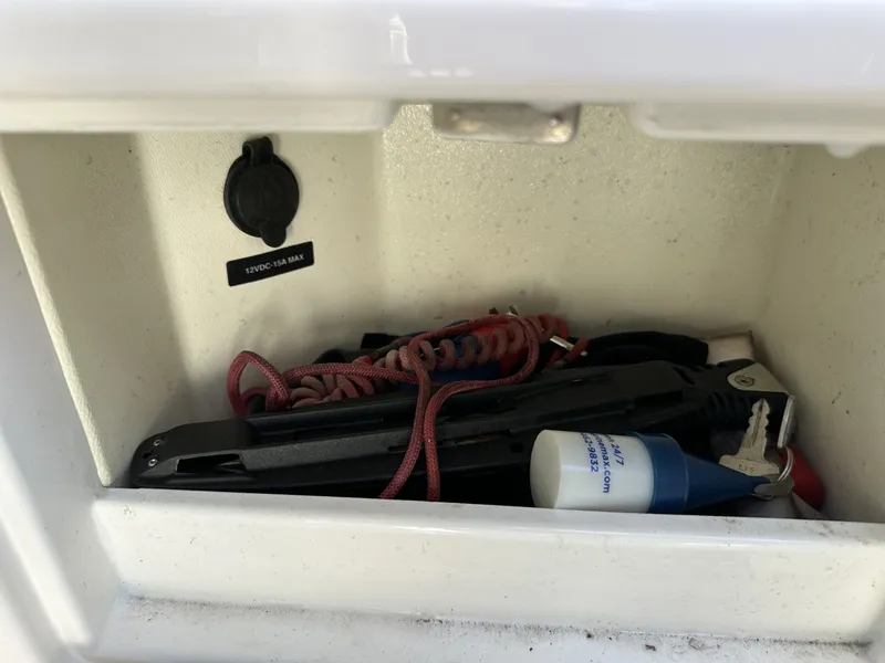 Slide: The Image of A storage compartment with tools and accessories on a Sea Ray Sundancer 260 boat. - 47