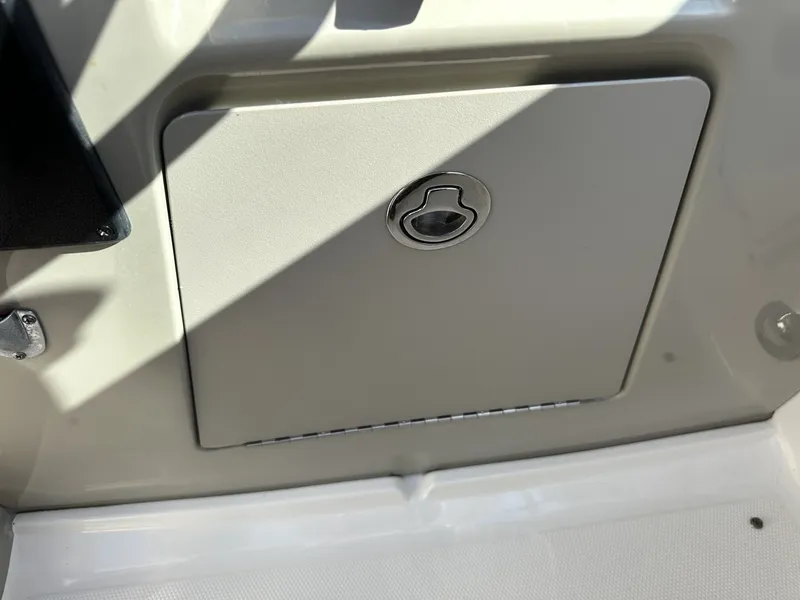 Slide: The Image of A closed storage compartment on a 2010 Sea Ray Sundancer 260 boat. - 48