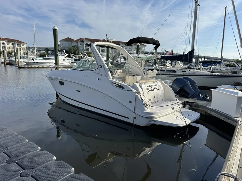 Slide: The Image of A 2010 Sea Ray Sundancer 260 docked in a marina, surrounded by other boats. - 7