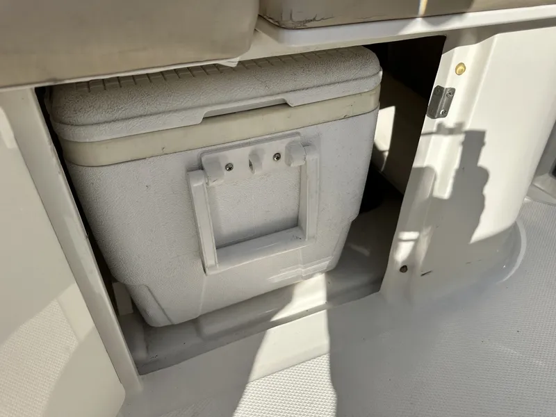 Slide: The Image of A white cooler is stored in a compartment on a boat. - 33