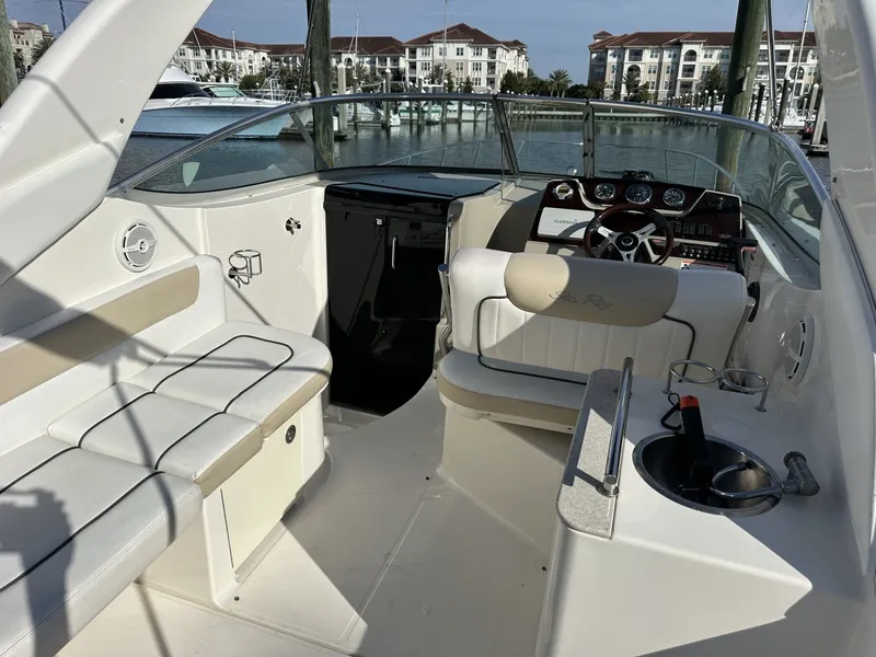 Slide: The Image of The image shows the cockpit of a 2010 Sea Ray Sundancer 260 with white seating and helm console. - 2
