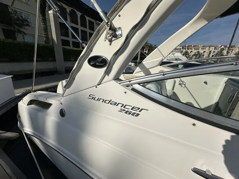 Slide: The Image of A 2010 Sea Ray Sundancer 260 with a sleek white hull and modern lines. - 17