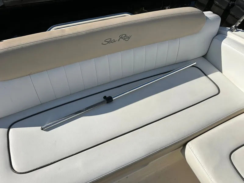 Slide: The Image of The 2010 Sea Ray Sundancer 260 bench seat with beige and white upholstery. - 27