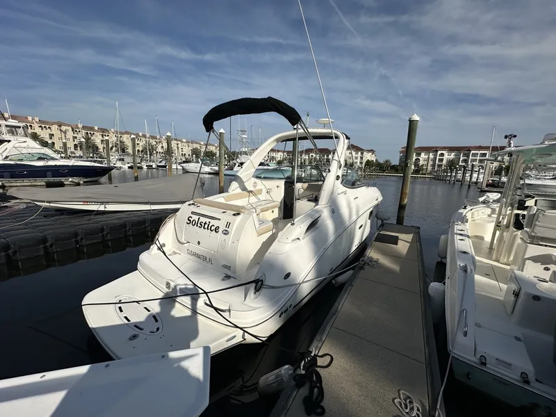 Slide: The Image of A 2010 Sea Ray Sundancer 260 docked at a marina, surrounded by other boats. - 1