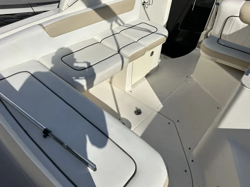 Slide: The Image of The image shows the seating area of a Sea Ray Sundancer 260 boat with white upholstery. - 4