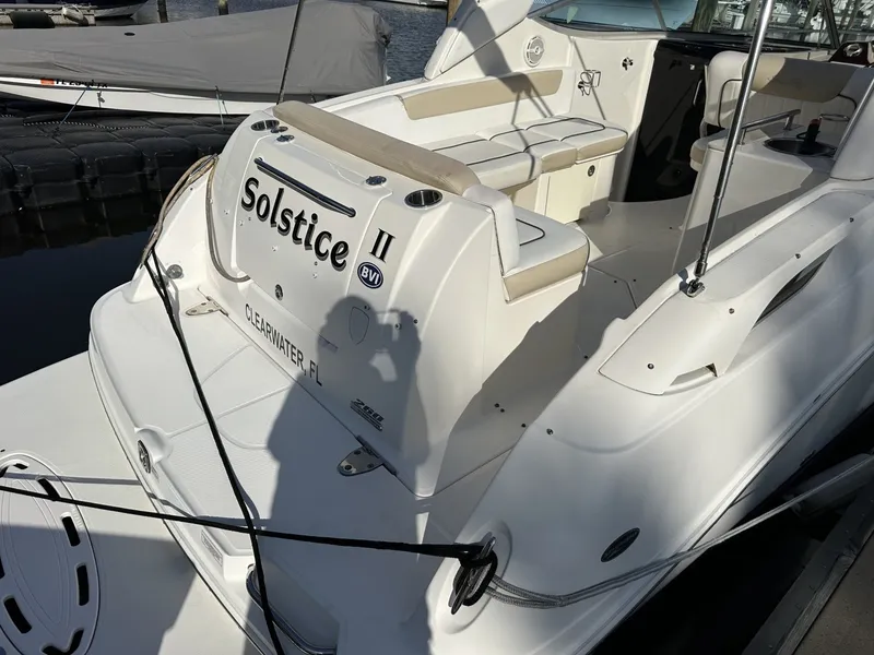 Slide: The Image of The image shows a 2010 Sea Ray Sundancer 260 docked at a marina. - 19