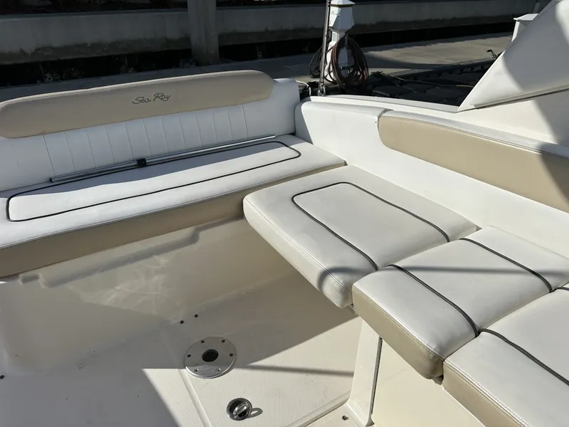 Slide: The Image of The image shows the seating area of a 2010 Sea Ray Sundancer 260 boat with beige upholstery. - 40