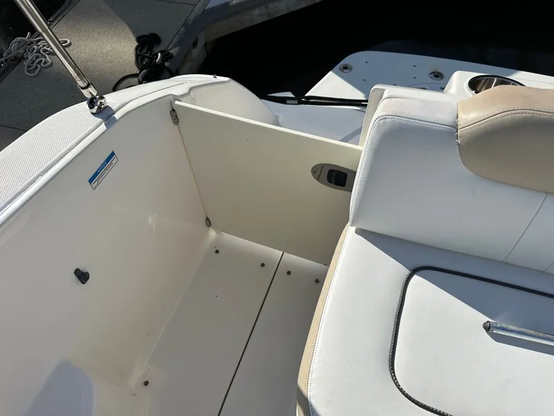 Slide: The Image of The image shows the seating area of a 2010 Sea Ray Sundancer 260 boat with white upholstery. - 26