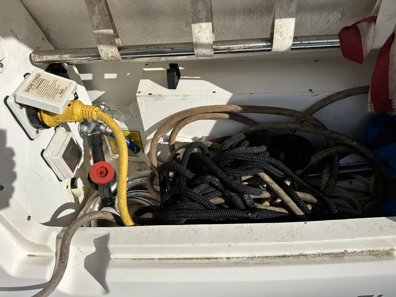Slide: The Image of A storage compartment on a boat with ropes and cables. - 21