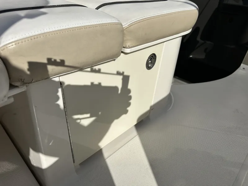Slide: The Image of Close-up of a white seating area on a boat with shadows and upholstery. - 32