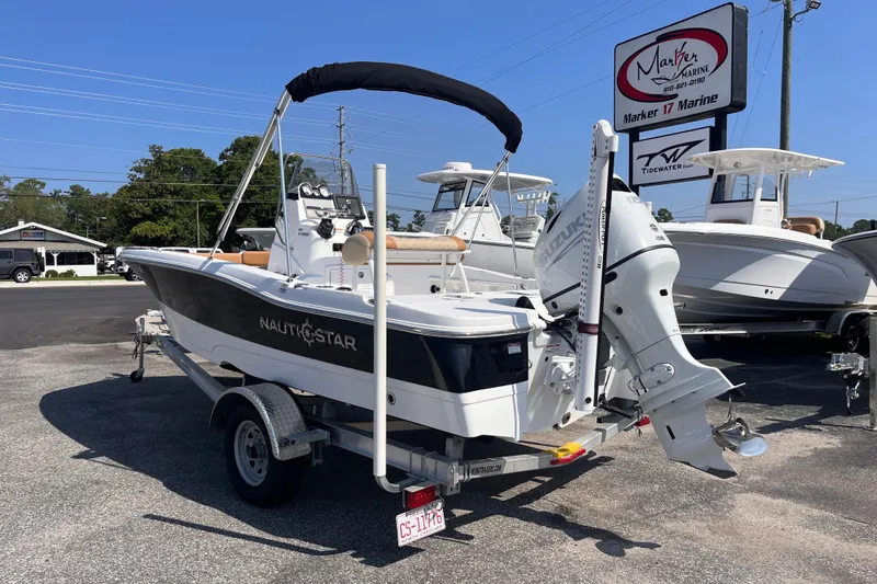 Slide: The Image of 2025 NauticStar 191 Hybrid boat on trailer at Marker 17 Marine dealership. - 2