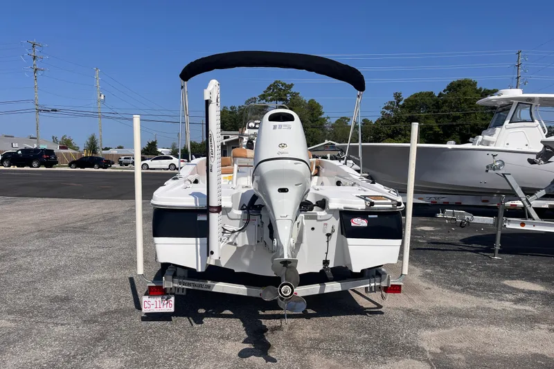 Slide: The Image of 2025 NauticStar 191 Hybrid boat on trailer, rear view, parked outdoors. - 3