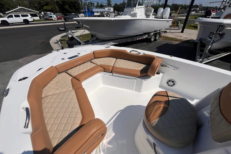 Slide: The Image of 2025 NauticStar 191 Hybrid boat with tan quilted seating, parked on a trailer. - 11