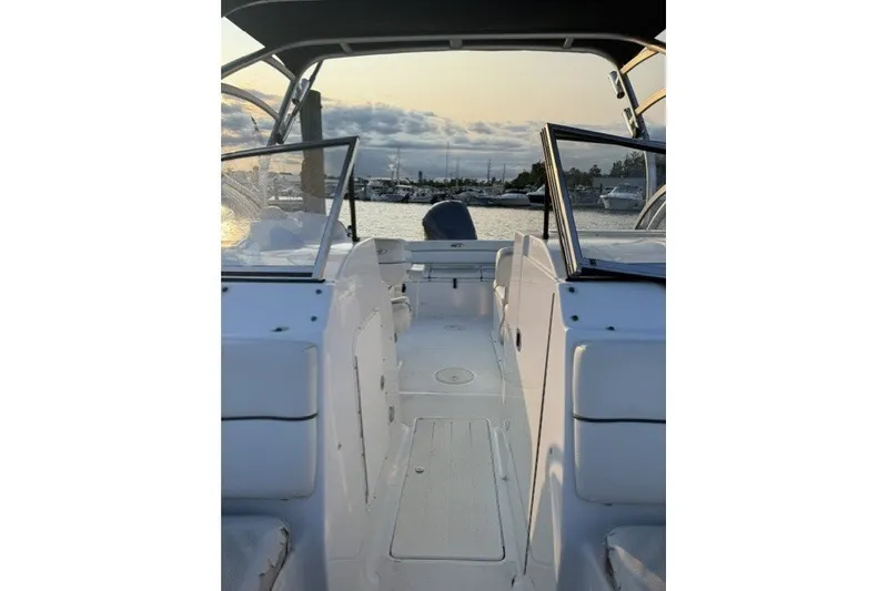 Slide: The Image of 2014 Sea Hunt Escape 234 LE boat interior with open deck and waterfront view. - 16