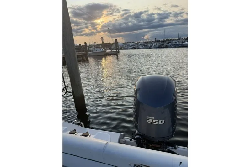 Slide: The Image of 2014 Sea Hunt Escape 234 LE with Yamaha 250 engine at sunset marina. - 13