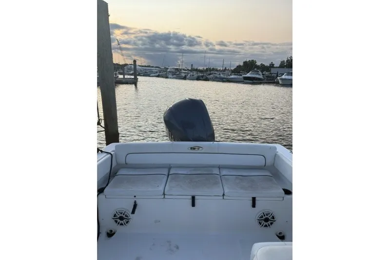 Slide: The Image of 2014 Sea Hunt Escape 234 LE boat at marina during sunset. - 18