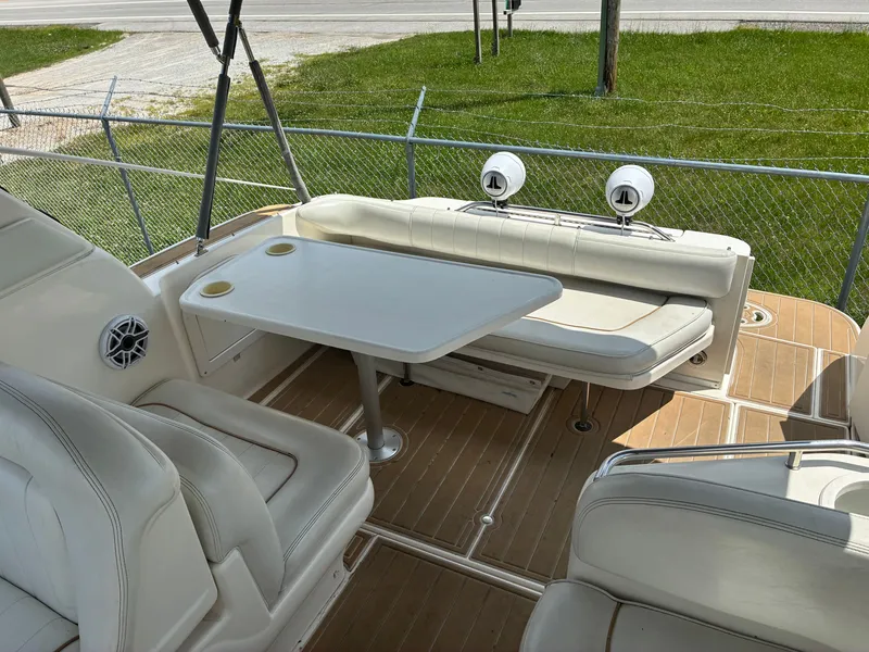 Slide: The Image of The image shows the cockpit of a 1998 Sea Ray 290 Sundancer with white leather seating and a table. - 8