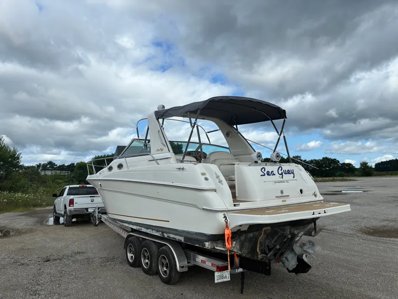 Slide: The Image of A 1998 Sea Ray 290 Sundancer on a trailer, ready for transport. - 3